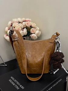 Retro brown bucket shoulder bag with textured leather and cute plush bear charm decoration