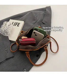 Macro shot of spacious interior capacity for brown leather bag with phones and wallet