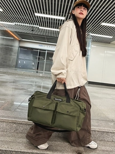 Army green large canvas tote bag with dual front pockets and adjustable shoulder strap