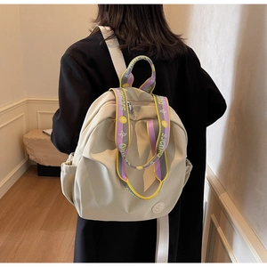 Detail of off-white nylon backpack featuring colorful lettered shoulder straps and logo