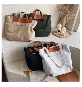Detailed display of large canvas tote bags in khaki, green, black and white color options