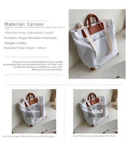 Detail view of white canvas tote bag with leather handles and size comparison chart