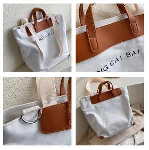 Detail shot of white canvas tote bag with brown leather handles and premium stitching