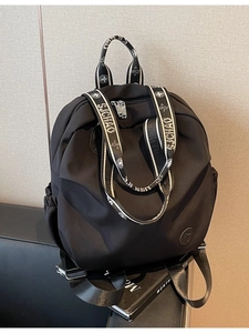 Minimalist black nylon backpack with stylish embroidered straps for daily travel commute