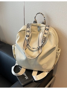 Minimalist beige nylon backpack with floral jacquard straps for casual travel use