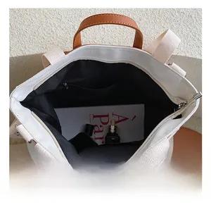 Top view of large canvas tote bag showing spacious black interior with a zipper pocket