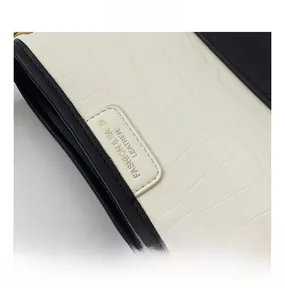 Detail of crocodile-textured white leather bag with gold FASHION & BAGS branding