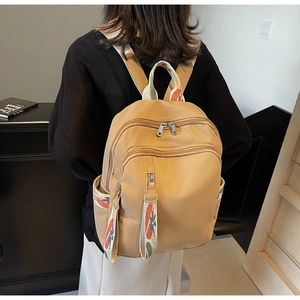 Detail of khaki nylon backpack featuring stylish jacquard webbing straps and large capacity