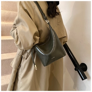 Detailed close-up of dark grey high-gloss hobo bag with NOFILTER printed logo