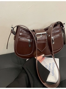 Deep brown glossy underarm bag with silver zippers and a retro buckle strap