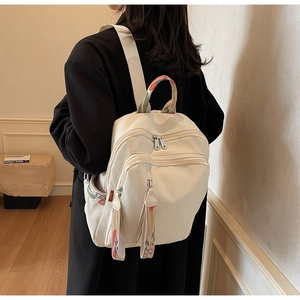 Detail of off-white backpack with colorful jacquard webbing and large capacity