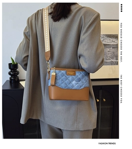Back view of model wearing a blue quilted denim crossbody bag with wide strap