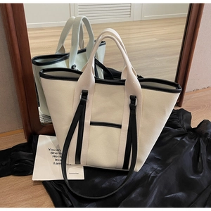 Detail of canvas tote bag with black trim and versatile dual strap system