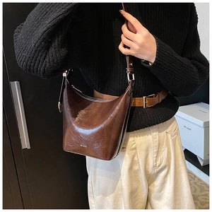 Detailed close-up of vintage brown leather bucket bag featuring NO FILTER embossed text