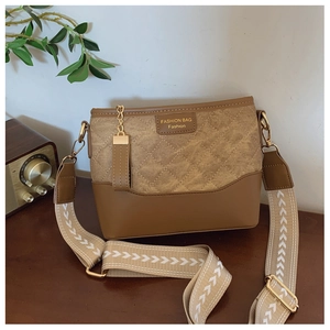 Close-up of brown quilted crossbody bag with jacquard strap and vintage radio decoration