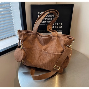 Brown corduroy tote bag detail with matching mini round coin purse and wide strap
