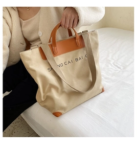Detail showing high-capacity canvas tote bag with leather straps and shoulder strap