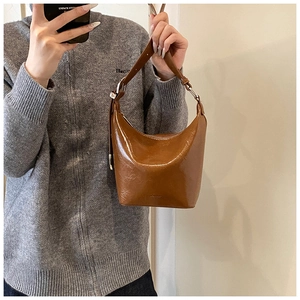 Detailed view of brown oil wax leather hobo bag with adjustable strap and silver hardware