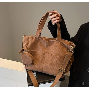 Brown corduroy tote bag with adjustable strap and small matching circular pouch detail