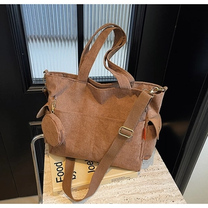 Detail of coffee brown corduroy tote bag with small round coin purse and side pocket