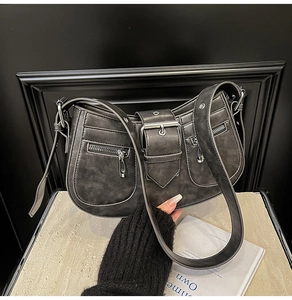Detail view of vintage grey shoulder bag with silver buckles and zipper pockets