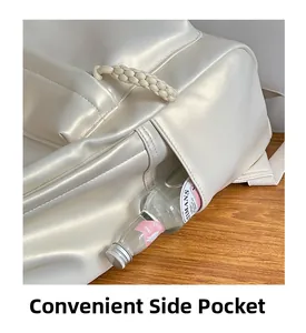 Detail view of the convenient side pocket on a minimalist beige leather backpack