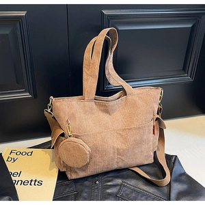 Detail view of khaki corduroy tote bag with textured stripes and mini round coin purse