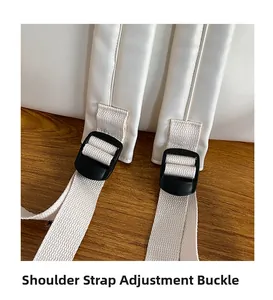 Detail of adjustable shoulder strap buckles on a minimalist white backpack