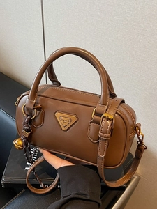 Classic dark brown Boston pillow bag in high-quality faux leather with gold triangle plaque