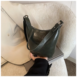 Close-up of vintage dark green oil-wax leather shoulder bag with NO FILTER text detail