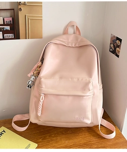 Detail of light pink PU leather backpack featuring silver bear charm and Hoog logo