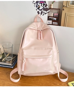 Detailed view of pink PU backpack showing the Hoog logo and woven zipper pullers