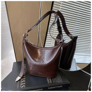 Detail of vintage brown leather underarm bag with NO FILTER text on textured surface