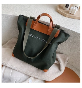 Detail of green canvas tote bag with brown leather handles on a white minimalist stair