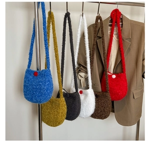 Showcase of fluffy wool bucket bags in six vibrant colors hanging on a metal rack