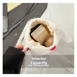 Detail view of the plush bucket bag interior with magnetic clasp and makeup storage
