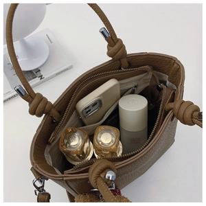 Detailed interior view of a brown pebbled leather tote bag showing spacious compartments