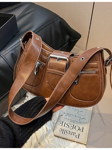Brown faux leather shoulder bag with silver hardware and wide multi-pocket strap