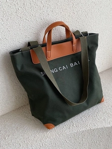 Retro canvas tote bag in dark green with brown leather handles and a shoulder strap