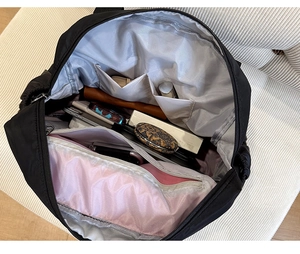 Interior view of black nylon backpack showing multiple compartments and large capacity