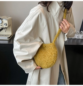 Close-up of yellow fuzzy plush bucket bag with soft texture and crossbody strap