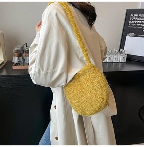 Detailed view of yellow faux fur bucket bag worn over shoulder in cozy style