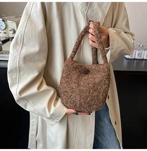 Detail of brown teddy fleece bucket bag with button showing soft wool texture