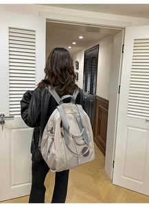 Close-up of lightweight nylon backpack in silver-grey with top handle and side pockets