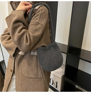 Dark grey fuzzy knit bucket bag styled with a brown herringbone wool coat in autumn scene