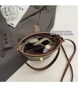 Top view of color-block bucket bag interior showing large capacity and zipper closure