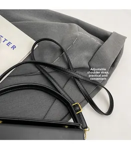 Detail of adjustable black leather strap with premium gold metal buckle and D-ring