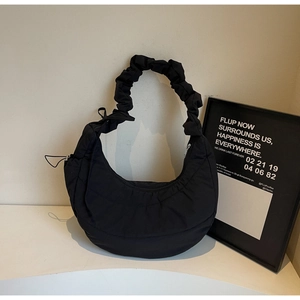 Close-up of quilted nylon hobo bag featuring ruched handle and puffer texture finish