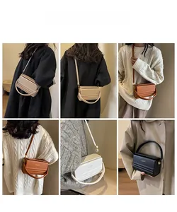 Detail view of box-shaped leather handbags in beige, brown, white and black colors