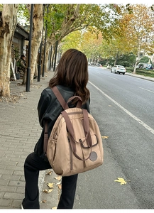 Waterproof nylon backpack in deep khaki featuring side zipper pockets for travel